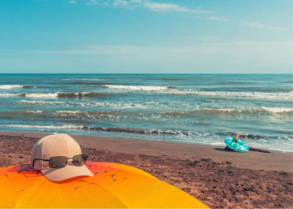 ocean, waves, sand, beach umbrella and hat